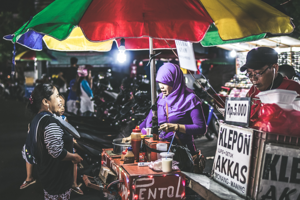 woman with child buying in a local market