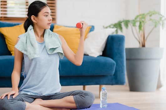 recreational activities during pandemic - a girl doing home exercise