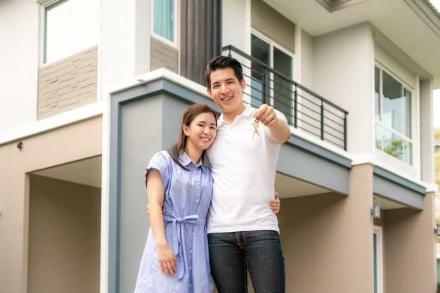 couple in front of house