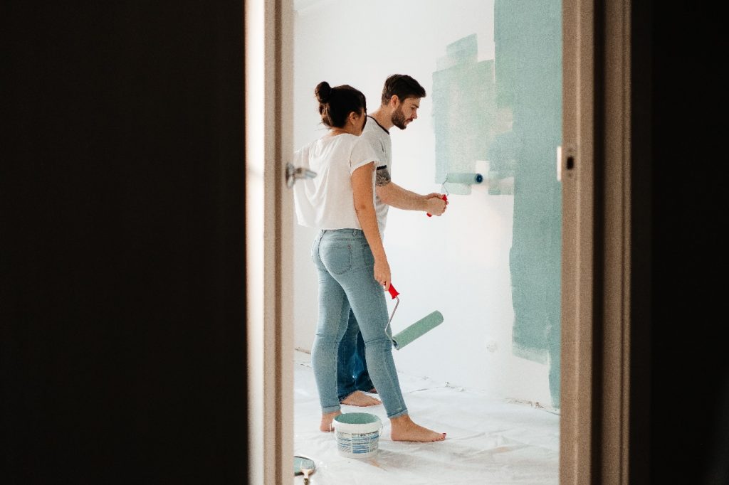 affordable home improvements - couple painting wall