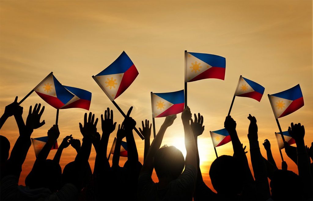 filipinos holding philippine flag