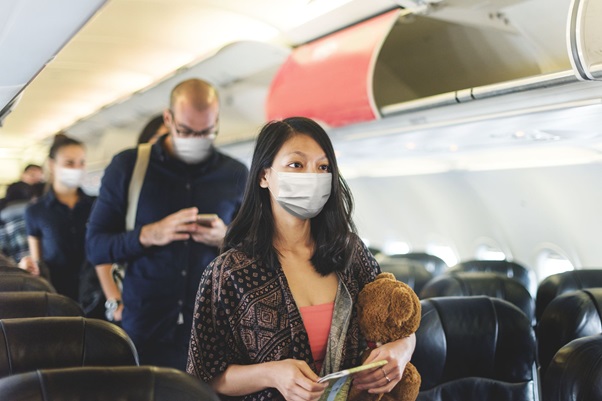 passengers in airplane wearing mask